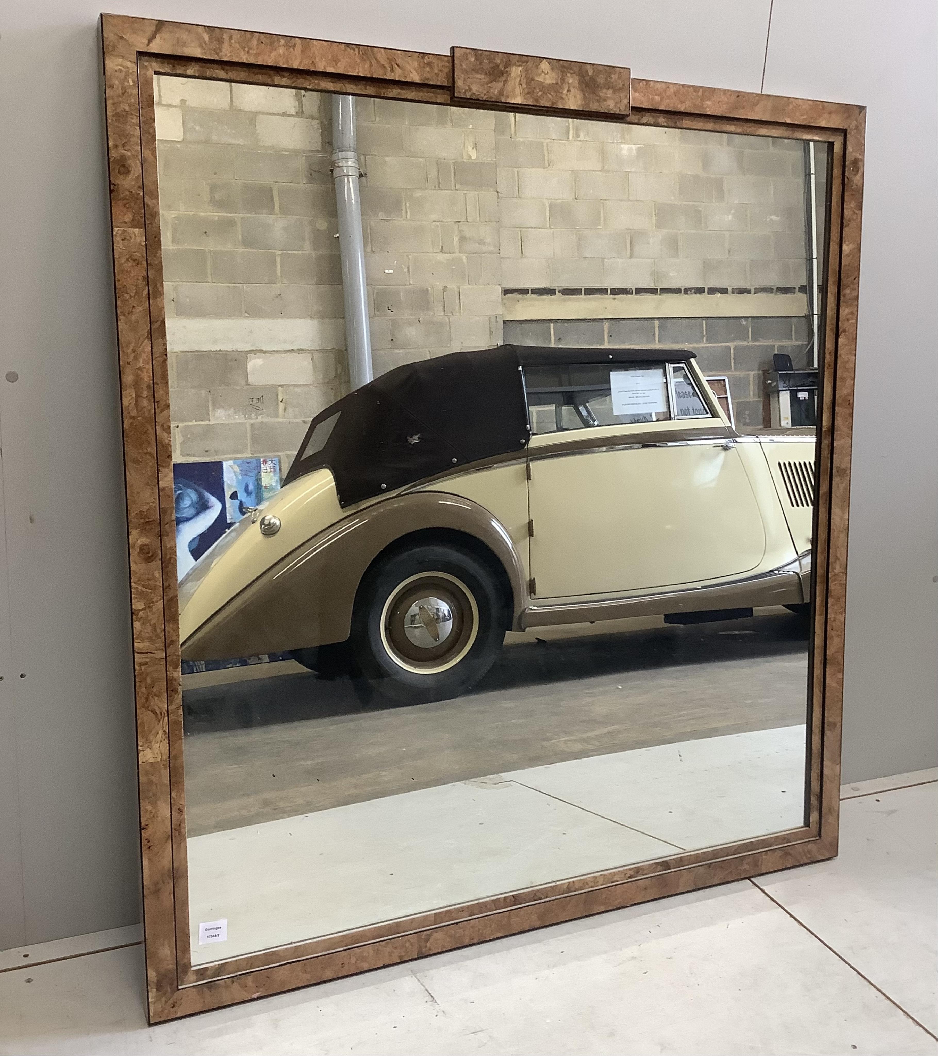 An Art Deco style sweetgum veneered rectangular overmantel mirror